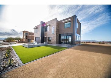 Contemporary two-story home with desert landscaping and unique water feature at 3530 S Spring Mountain Blvd Ct, Pahrump, NV 89048