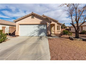 Charming single-story home featuring a well-maintained front yard and a two-car garage in a Gathering-friendly neighborhood at 5128 Canary Island Ct, North Las Vegas, NV 89031