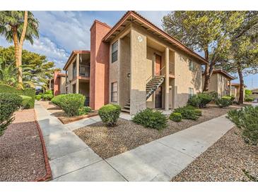 Two-story condo complex with well-maintained landscaping, sidewalks, and stairs to upper units at 5576 W Rochelle Ave # 27C, Las Vegas, NV 89103