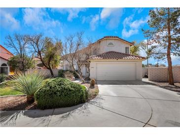 Charming two-story home with a red tile roof, well-manicured landscaping, and attached two car garage at 409 Rutherford Cir, Las Vegas, NV 89123