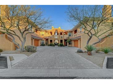 Charming townhouse featuring a terra cotta roof, decorative windows, and lovely desert landscaping at 820 Canterra St # 1054, Las Vegas, NV 89138