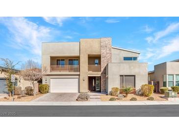 Contemporary two-story home featuring stone accents, balcony, and manicured landscaping at 3004 Barrett Springs Ave, Henderson, NV 89044
