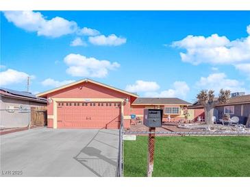Charming single-story home featuring a colorful exterior, attached garage, and well-maintained lawn with ornamental decorations at 3920 Geist Ave, Las Vegas, NV 89115