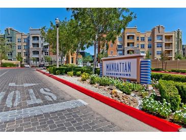Manhattan Condominiums community entrance with colorful building exteriors and manicured landscaping at 62 E Serene Ave # 114, Las Vegas, NV 89123