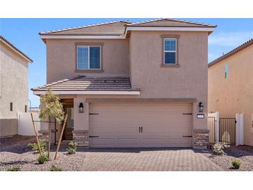 Two-story home with a stucco exterior, tile roof, and a two-car garage, complemented by a well-maintained front yard at 6252 Blood Lily Ave, Las Vegas, NV 89122