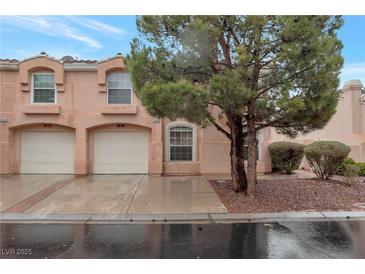 Charming townhome featuring an attached garage and well-maintained landscaping at 8440 Wandering Sun Ave, Las Vegas, NV 89129