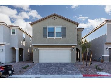 Charming home with brick driveway, two-car garage, and neutral color scheme at 9099 Nostrand Ave, Las Vegas, NV 89148