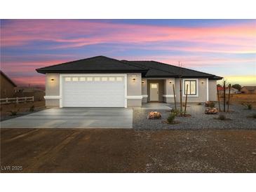 Charming single-story home boasts a well-manicured lawn and inviting curb appeal at 60 E Jaybird St, Pahrump, NV 89048