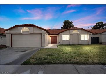 Charming single-story home featuring a well-maintained lawn and a two-car garage at 6413 Chippindale Ln, Las Vegas, NV 89108