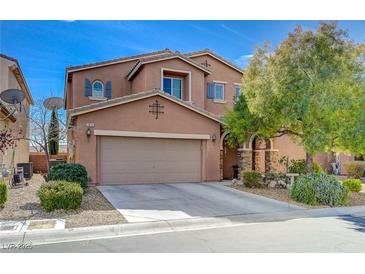 Two story home with a two car garage, desert landscaping, and attractive architectural details at 7815 Red Rock Ridge Ave, Las Vegas, NV 89179