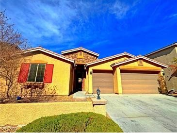 Charming single-story home featuring a two-car garage and desert landscaping at 1630 Meadow Bluffs Ave, Henderson, NV 89014