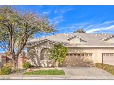 Charming single story home with mature tree, two-car garage, and manicured front lawn at 258 Spring River Ave, Las Vegas, NV 89123