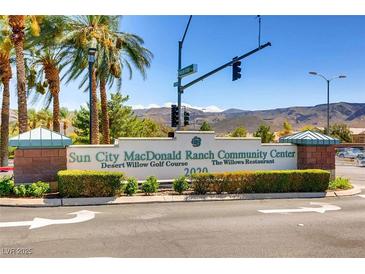 Sun City MacDonald Ranch Community Center sign surrounded by lush landscaping and palm trees on a sunny day at 538 Cypress Gardens Pl, Henderson, NV 89012