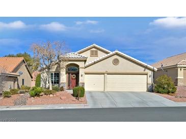 Charming single-story home featuring a two-car garage and a well-maintained landscaped front yard at 688 Quiet Stream Ct, Henderson, NV 89052