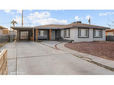 Charming single-story home featuring a spacious driveway and covered parking at 1100 H St, Las Vegas, NV 89106