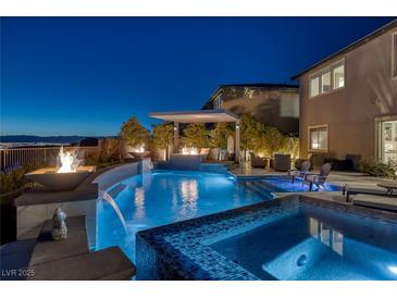 Stunning pool with spa, fire features, and covered patio is perfect for outdoor entertaining with scenic views at 2171 King Crest Ct, Henderson, NV 89052