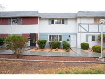 Townhouse-style home with tidy landscaping in front at 223 Greenbriar Townhouse Way, Las Vegas, NV 89121