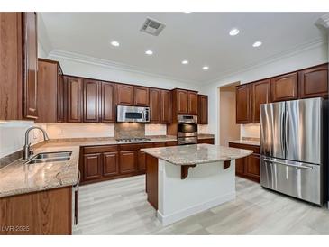 Spacious kitchen features custom wood cabinets, granite countertops, and stainless steel appliances at 2388 Orangeburg Pl, Henderson, NV 89044