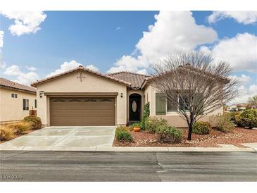 Charming single-story home featuring a tile roof, attached garage, and lovely desert landscaping at 4459 Lavender, Pahrump, NV 89061