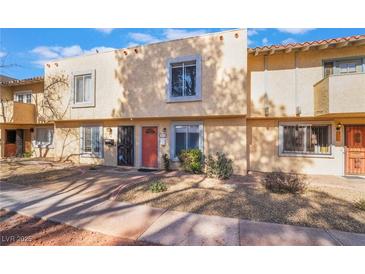 View of townhome featuring a stucco exterior with a well maintained yard at 466 Las Casitas Way, Las Vegas, NV 89121