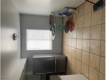 The kitchen features stainless steel appliances, including a refrigerator, and tile flooring at 4774 Lucite Ln, Las Vegas, NV 89115