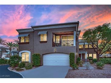 Charming two-story townhome featuring a balcony, a two-car garage, and meticulous landscaping at 9425 San Laguna Ct # 102, Las Vegas, NV 89134