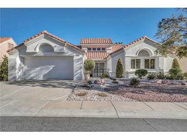 Charming single-story home featuring a well-manicured front yard and a two-car garage at 9704 Brawley Dr, Las Vegas, NV 89134