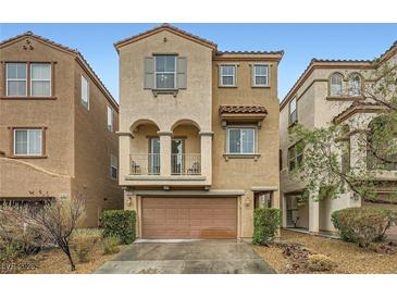 Charming two-story home featuring a balcony, a two-car garage, and desert landscaping at 10808 Holmfield St, Henderson, NV 89052