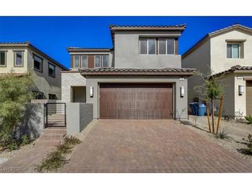 Two-story home with a two-car garage and brick driveway at 109 Medianoche St, Las Vegas, NV 89138