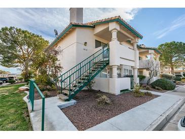 Two-story condo featuring a private entry staircase, desert landscaping, and a well-maintained facade at 1412 Oak Rock Dr # 202, Las Vegas, NV 89128