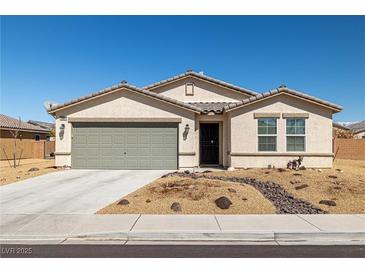 Charming single-story home with a low-maintenance desert landscape and attached two-car garage at 3924 E Garfield Dr, Pahrump, NV 89061