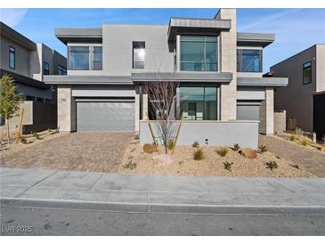 Contemporary two-story home showcasing modern design elements and a well-maintained front yard at 4880 Argento Peak St, Las Vegas, NV 89135