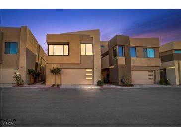 Modern home showcasing clean lines, neutral tones, and a two-car garage at 9 Promenade Isle Ln, Henderson, NV 89011