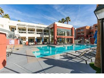 Resort-style pool and lounge area with modern architecture and manicured landscaping at 23 E Agate Ave # 303, Las Vegas, NV 89123