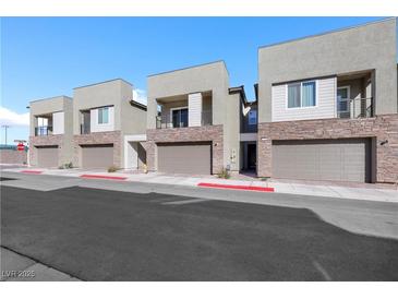 Modern townhome exteriors with stone accents and private balconies showcase contemporary design at 234 Walsh Peak Ave, Henderson, NV 89015