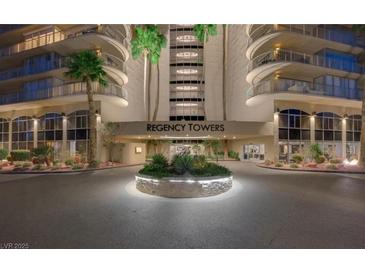 Elegant Regency Towers entrance featuring a lush roundabout and well-maintained landscaping at 3111 Bel Air Dr # 15D, Las Vegas, NV 89109