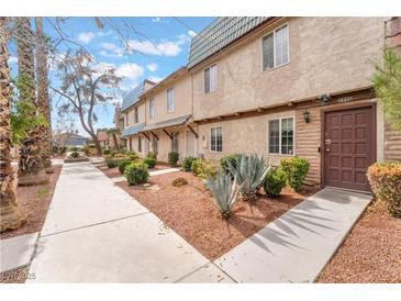 Charming townhome featuring a well-manicured front yard with desert landscaping and a private entrance at 3986 Visby Ln, Las Vegas, NV 89119