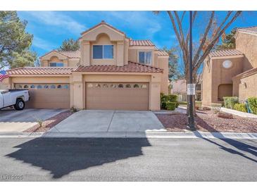 Inviting townhome with a two-car garage and classic desert landscaping at 5305 La Patera Ln, Las Vegas, NV 89149
