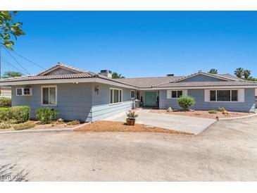 Charming single-story home with a well-maintained lawn and blue-painted exterior at 5350 Topaz St, Las Vegas, NV 89120