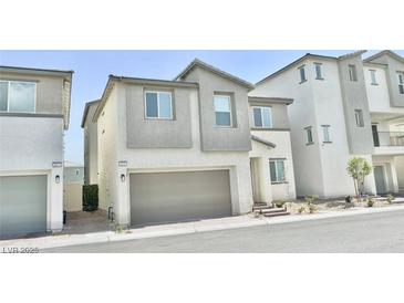 Charming two-story home with neutral colors, attached garage, and manicured landscaping at 6840 Sunflower Fields St, North Las Vegas, NV 89086