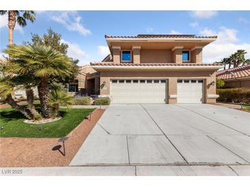 Charming home featuring a three-car garage, well-maintained landscaping, and a welcoming entrance at 8904 Saint Pierre Dr, Las Vegas, NV 89134