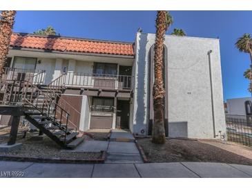 Charming two-story condo with brown accents, complemented by desert landscaping and a red tile roof at 1405 E Vegas Valley Dr # 112, Las Vegas, NV 89169