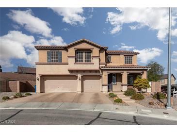 Charming two-story home featuring a three-car garage, landscaped front yard, and inviting front porch at 23 Crescent Palm Ct, Henderson, NV 89002