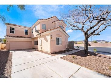 Two-story home features a tile roof, large driveway, and low-maintenance landscaping at 2407 Belt Buckley Dr, Henderson, NV 89002