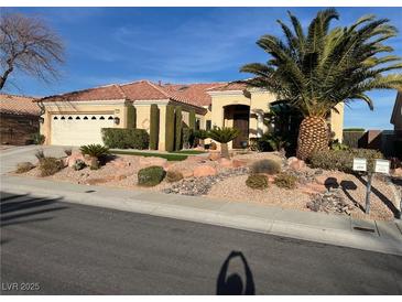 Charming single-story home showcasing a desert landscape, mature palm trees, and a welcoming two-car garage at 2536 Faiss Dr, Las Vegas, NV 89134