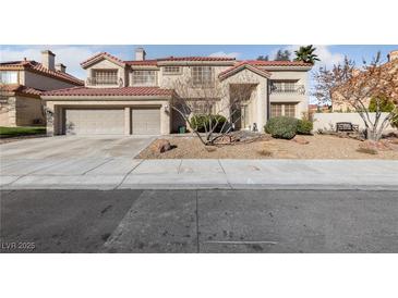 Charming home boasts a red tile roof, stucco facade, and a spacious three-car garage at 2637 Ohio Ct, Las Vegas, NV 89128