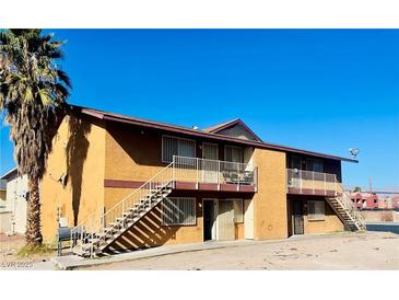 Two-story building featuring staircases, balconies, and a desert landscape at 4791 E Craig Rd, Las Vegas, NV 89115