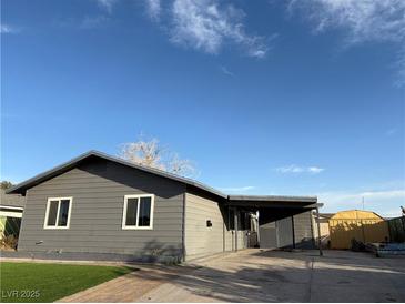 Charming single-story home features a gray exterior, covered carport, and well-maintained artificial lawn at 5194 Saratoga Dr, Las Vegas, NV 89120