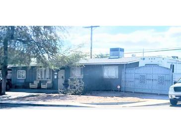 Modest single story home featuring a gated entry, mature trees, and an enclosed front yard at 5617 Tanya Ave, Las Vegas, NV 89107