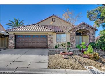 Charming single-story home featuring desert landscaping, a brick facade and a two-car garage at 6587 Lucky Boy Dr, Las Vegas, NV 89110